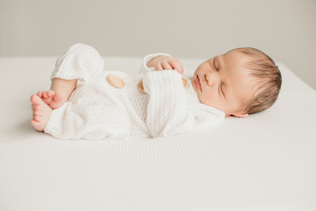 baby boy laying on the bed for Eugene Oregon newborn photography studio