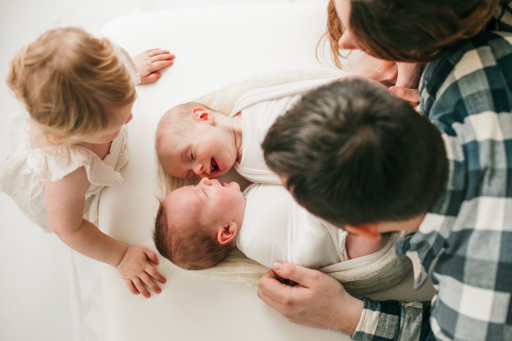 toddler sibling with parents during newborn photoshoot in eugene oreogn