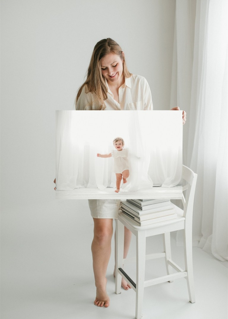 Heidi Rakas holding a canvas print from 1st year birthday photography session in Eugene, Oregon