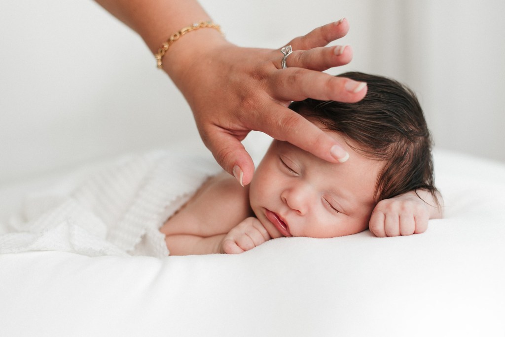 a newborn baby laying down on his tummy during his newborn session in eugene oregon