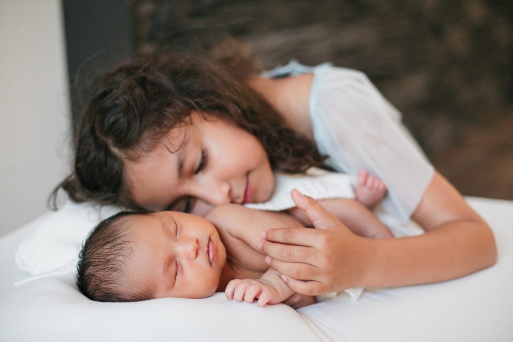 sibling love during an in home newborn session in eugene oregon